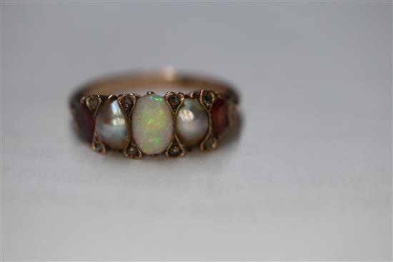 A Victorian 15ct, graduated white opal, split pearl and topaz? set half hoop ring, size O.